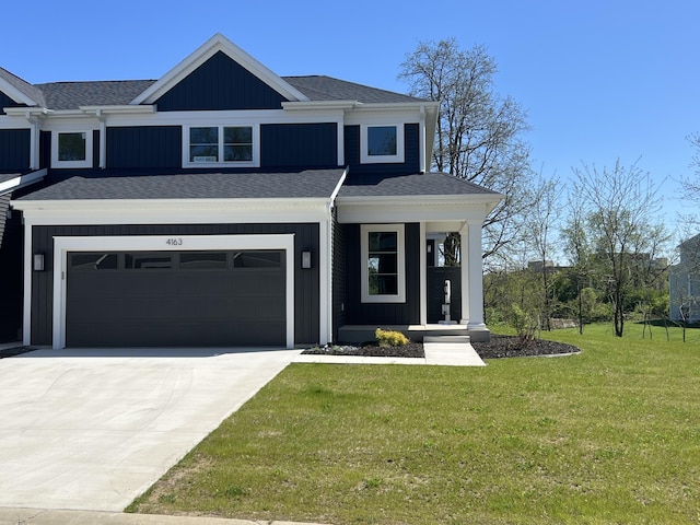 view of front of home featuring driveway, a front lawn, a garage, and a shingled roof