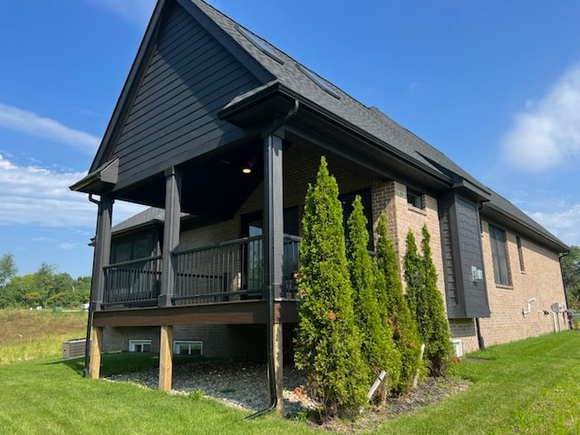 view of side of property with a lawn