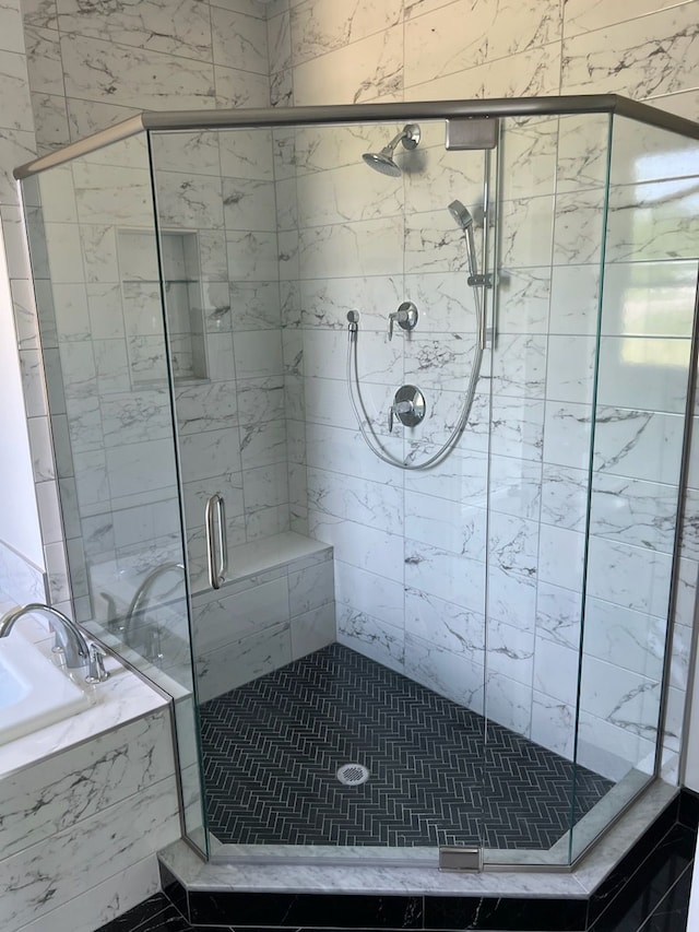 bathroom featuring separate shower and tub