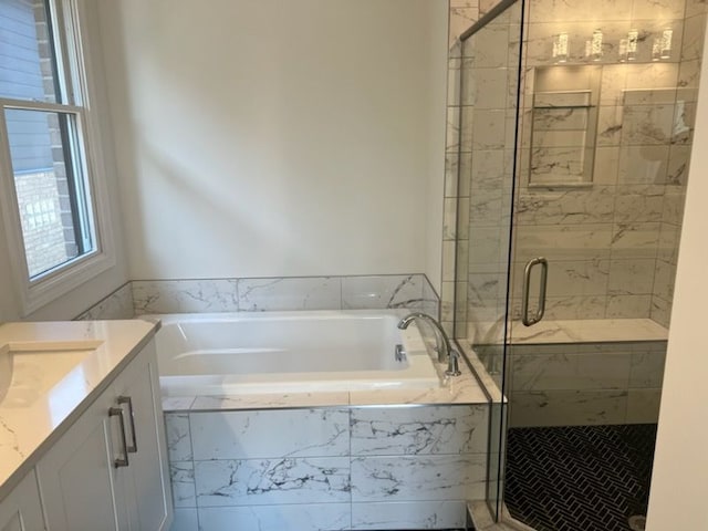 bathroom with shower with separate bathtub and vanity