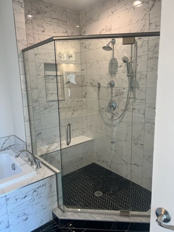 bathroom featuring separate shower and tub