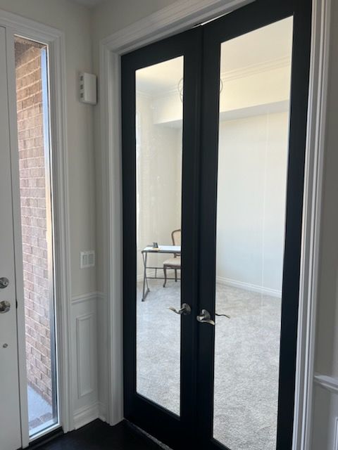 doorway featuring crown molding, french doors, and carpet floors