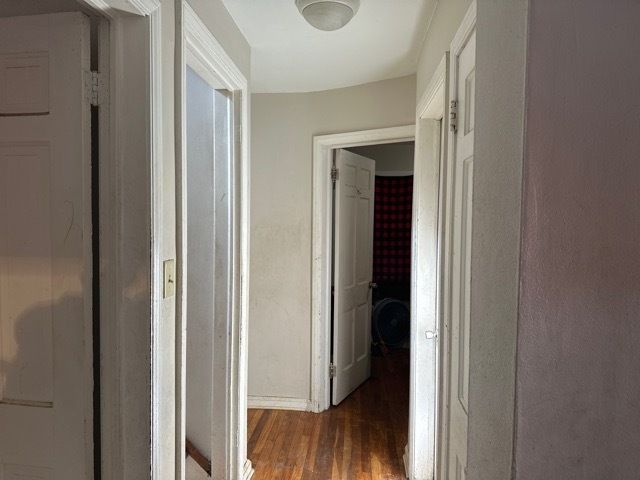 corridor featuring dark hardwood / wood-style floors