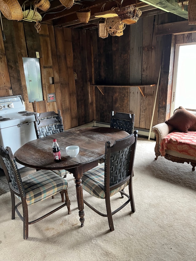 carpeted dining space featuring washer / dryer, electric panel, and wood walls