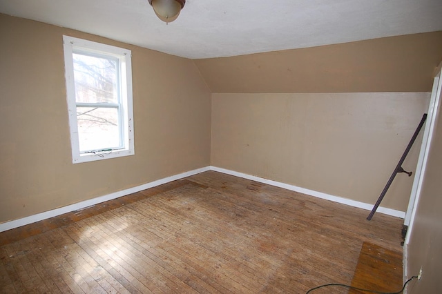 bonus room with wood-type flooring and lofted ceiling