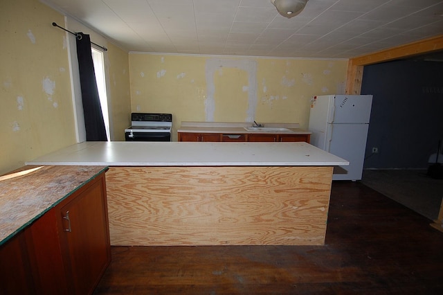 kitchen featuring white appliances, dark wood-type flooring, and sink