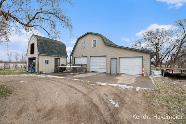 exterior space with an outbuilding and a garage