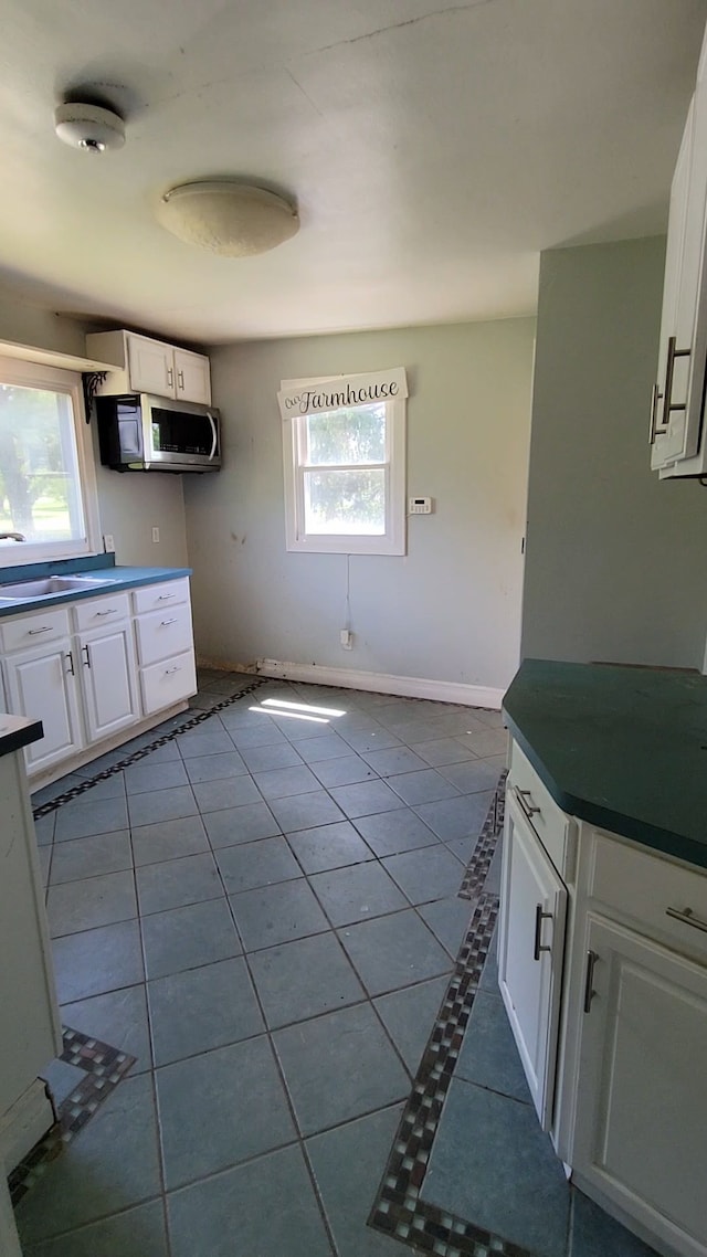 kitchen with white cabinetry, plenty of natural light, and light tile patterned floors