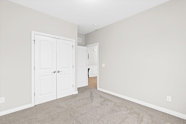 362 Jubilee Dr, Whitmore Lake, MI 48189 - unfurnished bedroom with carpet floors, a closet, and baseboards