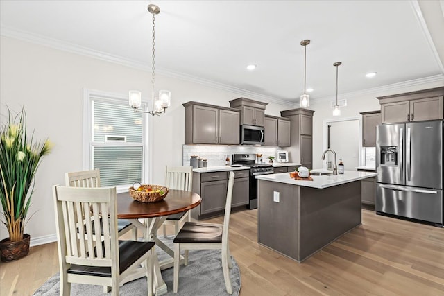 362 Jubilee Dr, Whitmore Lake, MI 48189 - kitchen featuring stainless steel appliances, a sink, light countertops, ornamental molding, and backsplash