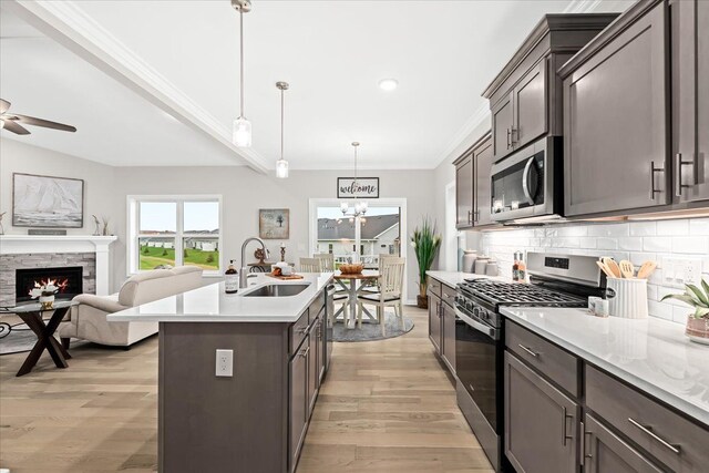 362 Jubilee Dr, Whitmore Lake, MI 48189 - kitchen with stainless steel appliances, a sink, ornamental molding, light countertops, and decorative backsplash