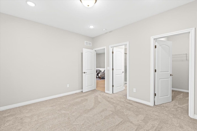 362 Jubilee Dr, Whitmore Lake, MI 48189 - unfurnished bedroom with light colored carpet, a walk in closet, baseboards, a closet, and recessed lighting