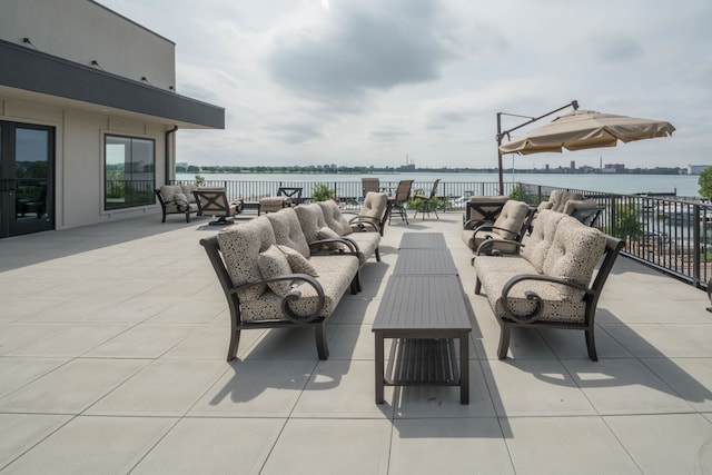 view of patio featuring an outdoor living space and a water view