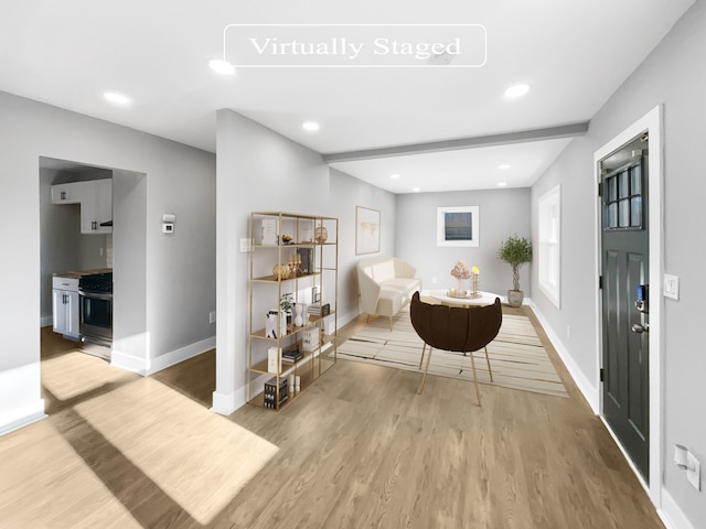 interior space with beamed ceiling and light hardwood / wood-style flooring