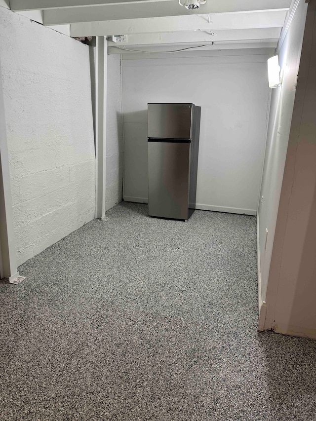 basement with stainless steel refrigerator