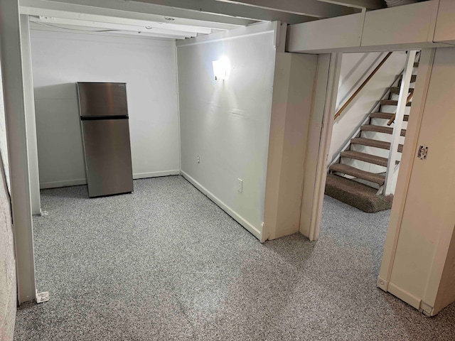 basement with stainless steel refrigerator