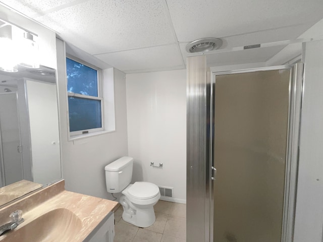 bathroom with tile patterned floors, a shower with door, vanity, and toilet