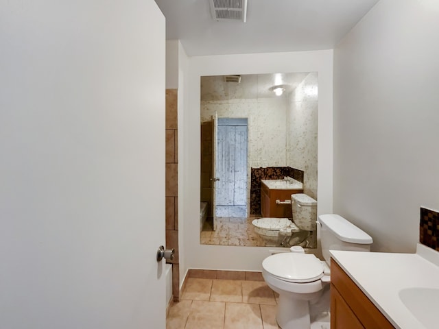 bathroom with tile patterned flooring, vanity, and toilet