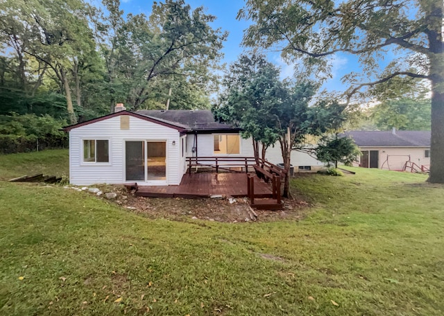 back of house with a yard and a deck