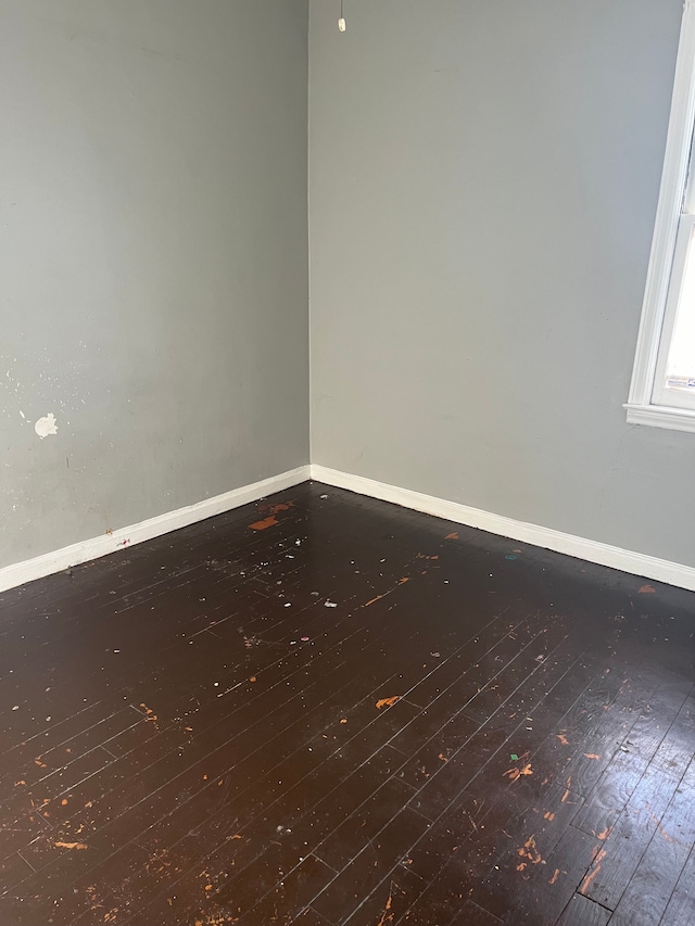 empty room with dark wood-type flooring