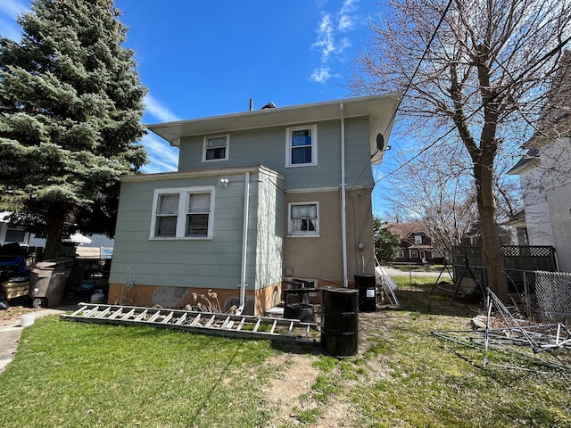 rear view of property with a yard