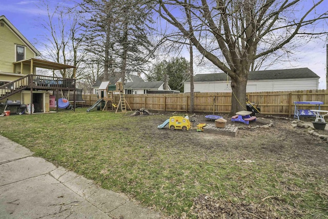 view of yard featuring a playground and a deck