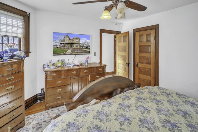 bedroom with light wood-type flooring and ceiling fan