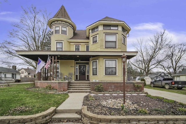 victorian-style house with covered porch and a front lawn