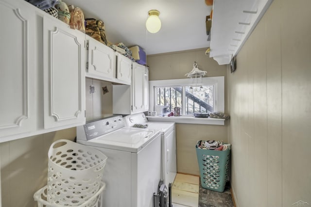 washroom with cabinets and washing machine and clothes dryer