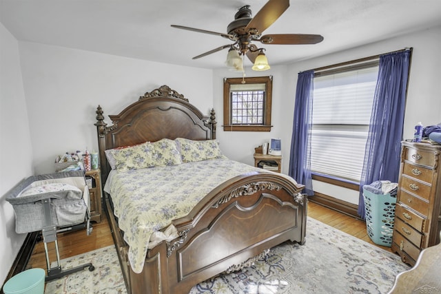 bedroom with ceiling fan and light hardwood / wood-style flooring