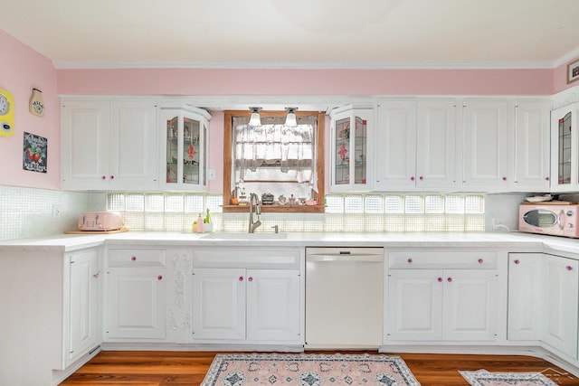 kitchen with white appliances, white cabinets, sink, light hardwood / wood-style flooring, and decorative backsplash