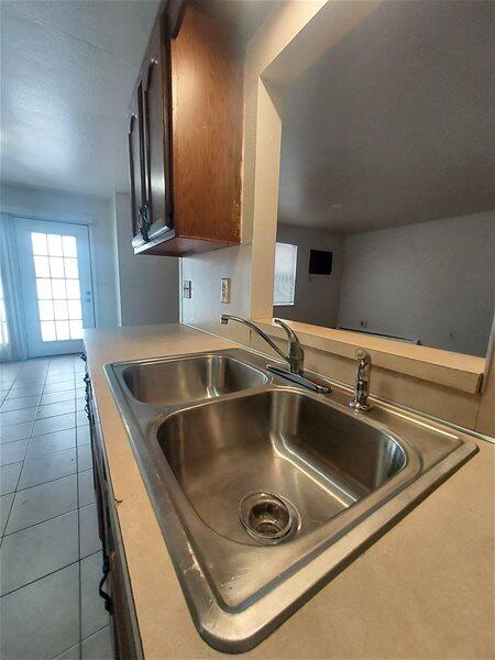 kitchen with sink and dark tile patterned floors