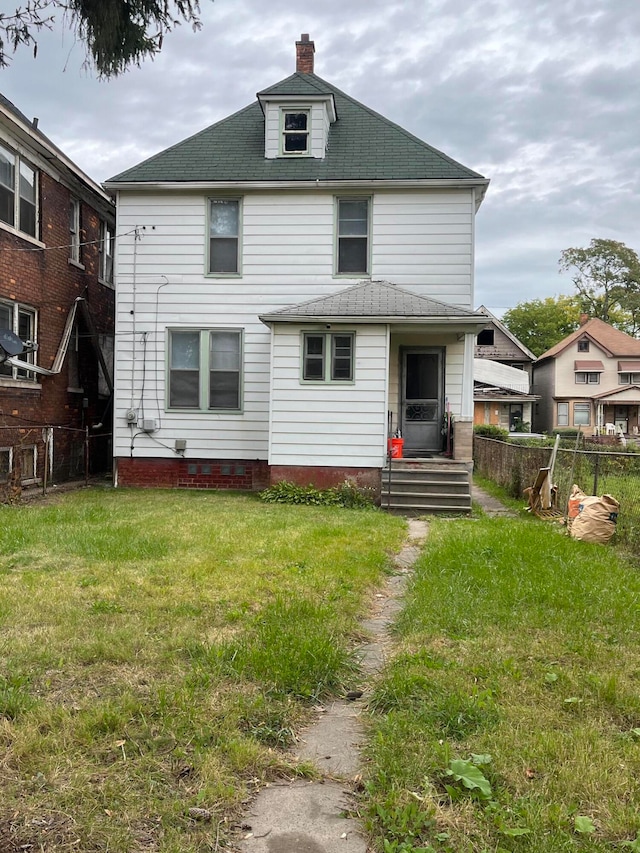 back of house featuring a yard