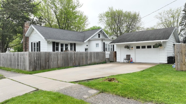 view of front facade with a garage and a front lawn