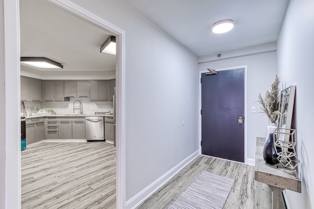 entrance foyer with sink and light hardwood / wood-style flooring