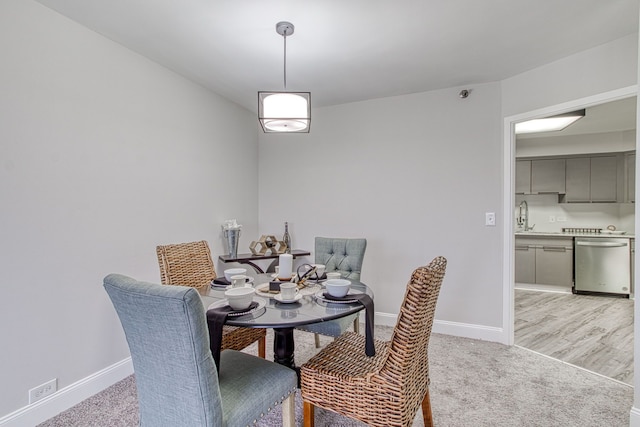 dining room with light wood-type flooring and sink