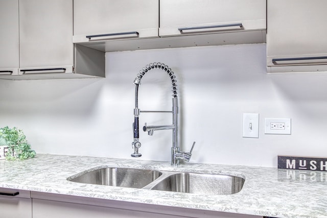 kitchen with light stone counters and sink