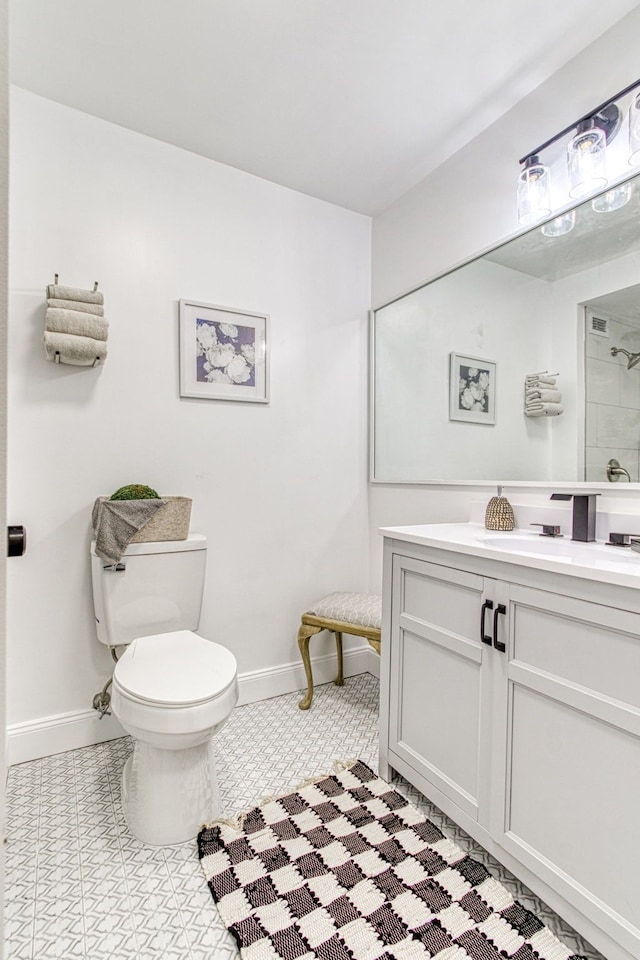 5000 Town Ctr Unit 2205, Southfield, MI 48075 - bathroom featuring toilet, baseboards, vanity, and tiled shower