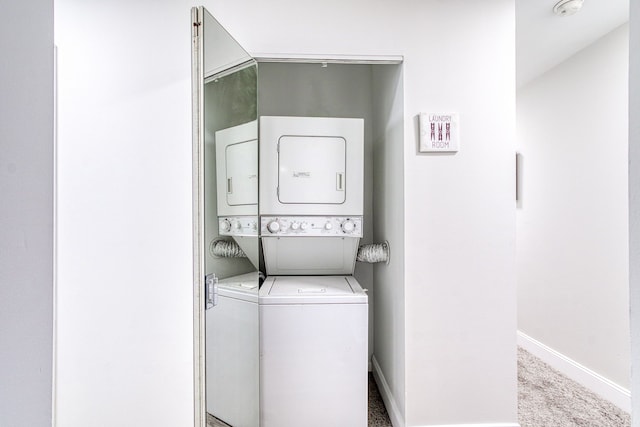 washroom featuring light carpet and stacked washing maching and dryer