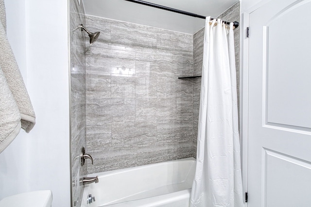 bathroom featuring toilet and shower / tub combo with curtain