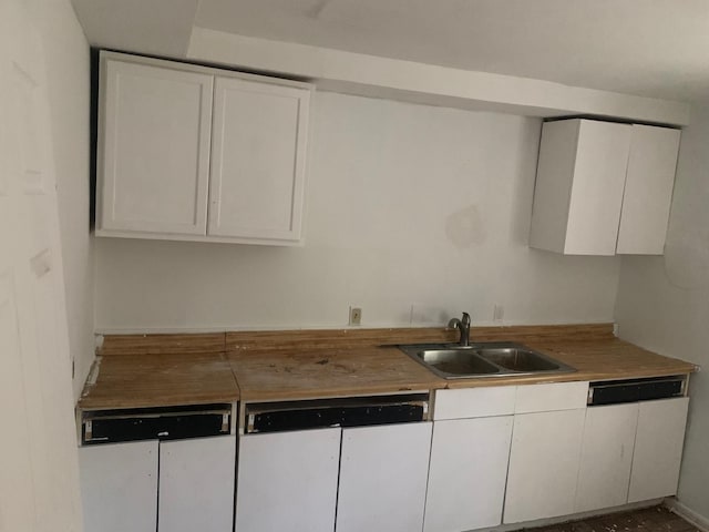 kitchen with white cabinetry and sink