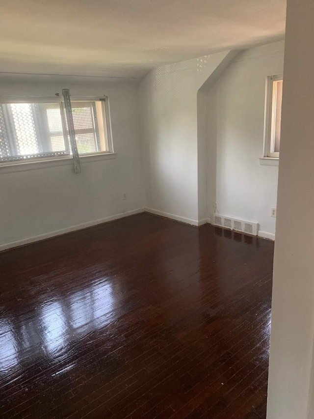 unfurnished room with dark hardwood / wood-style floors