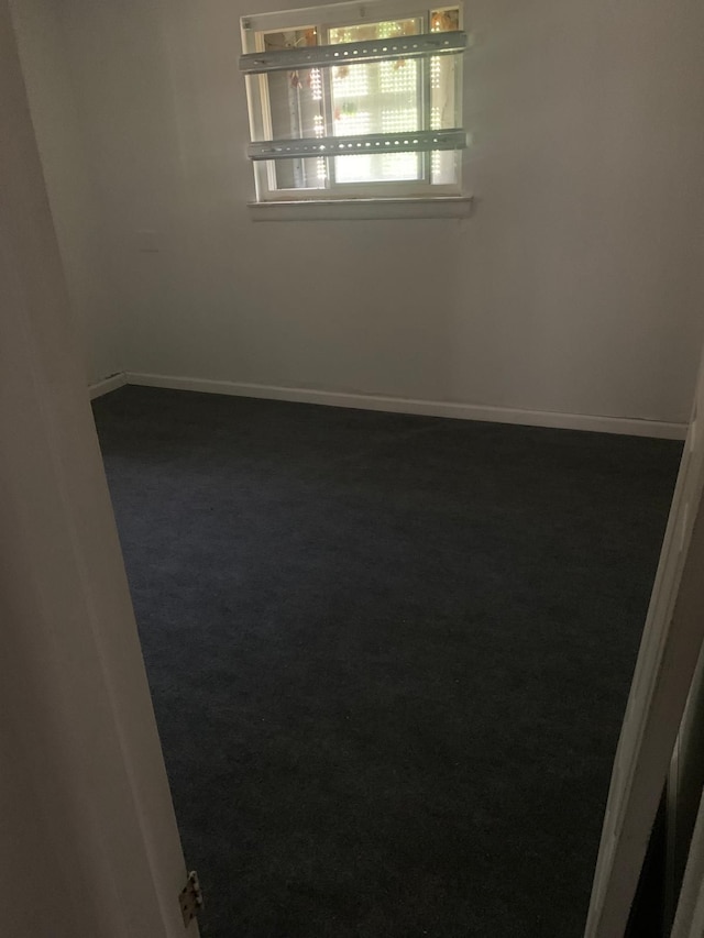 empty room with dark carpet