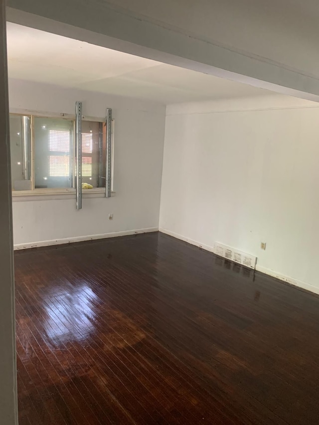 spare room featuring dark hardwood / wood-style flooring