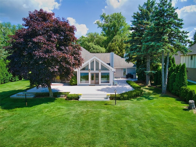 back of house featuring a lawn