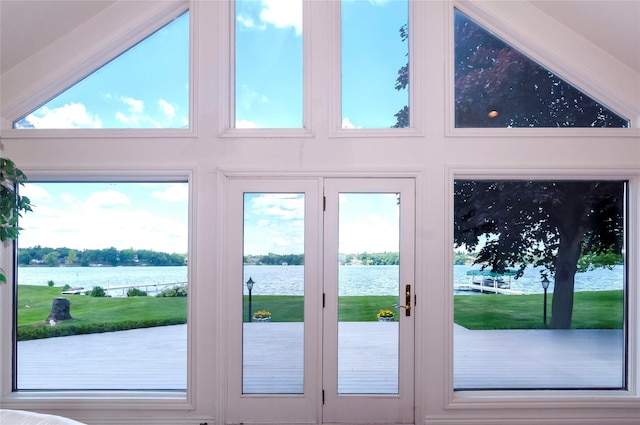 doorway to outside featuring a water view and high vaulted ceiling