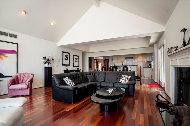 living room with beamed ceiling, dark hardwood / wood-style flooring, and high vaulted ceiling