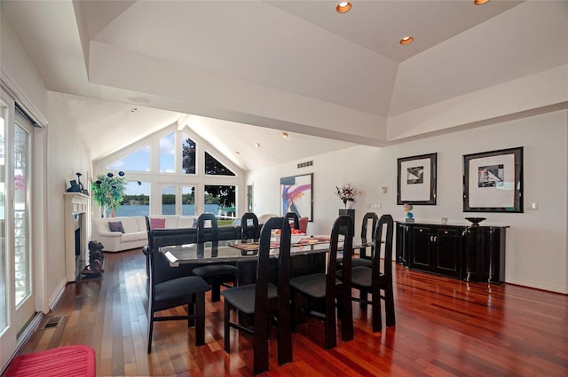 dining room with high vaulted ceiling, a wealth of natural light, and dark wood-type flooring