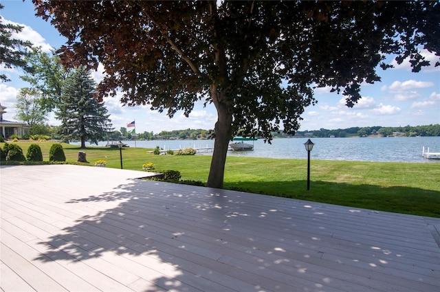 wooden deck featuring a water view and a yard