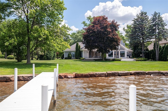 view of dock featuring a yard and a water view